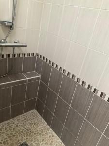 a shower with gray and white tiles and a tub at Maison bercée par le bruit de la mer île de ré in Sainte-Marie-de-Ré +19 photos