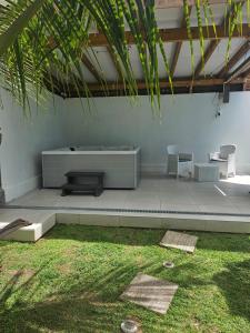 a room with a bench and chairs and grass at Sweet Colibri in Les Trois Ponts +5 photos