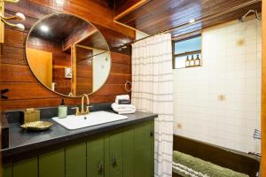 a bathroom with a sink and a mirror at Breathtaking Views Elevated Comfort Pets Welcome in Prescott +80 photos
