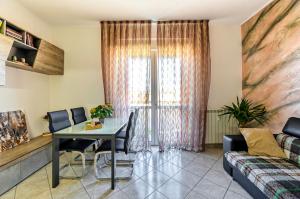 a living room with a table and chairs and a couch at La Casa di Hellen 2room &living room 5pers app in Saronno