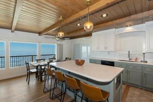 a kitchen with a table and chairs and a balcony at Lake Gregory Skyline Ridge in Crestline