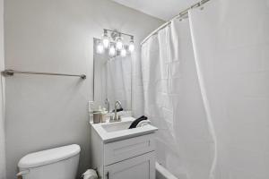 胡佛Stylish 2BR Duplex with Easy Access to Birmingham的带水槽和淋浴的白色浴室