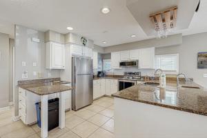 a kitchen with white cabinets and a stainless steel refrigerator at Town of Bethany Beach -116 Oakwood St in Bethany Beach