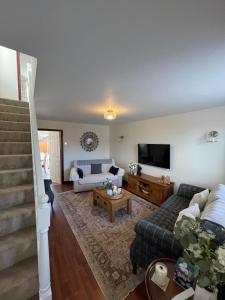 a living room with a couch and a tv at Bowling Green cottage in Wheaton Aston
