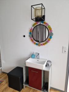 a bathroom with a sink and a mirror at Kleine Zimmer in Gästehaus in Feldkirch