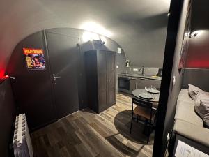 a small room with a small table and a kitchen at CinemaRoom - Netflix -Hyper Centre in Arras +52 photos