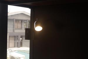 a light bulb on a door with a window at Ceiba Hostel in Fortuna