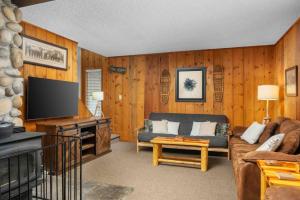 a living room with a couch and a flat screen tv at Mt. Hood Chalet in Government Camp
