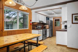 a kitchen with a wooden table and a large window at Mt. Hood Chalet in Government Camp