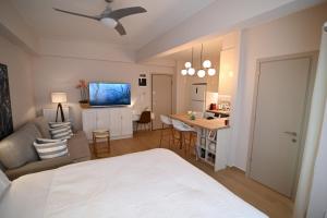 a bedroom with a bed and a living room and a kitchen at Lilaki in Larisa