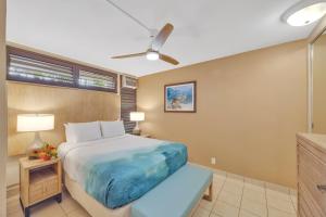 a bedroom with a large bed and a window at Kuleana Club #510 - Ocean View -1 bedroom & 1 bathroom - 2nd Floor in Kahana