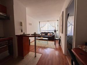 a living room with a table and a couch at Apartment in Santiago-Catedral in Santiago