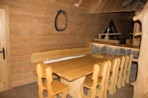 a dining room with a wooden table and chairs at Chata Pod Grapom in Czarna Góra
