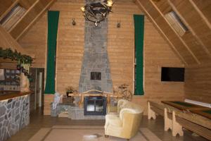 a large living room with a stone fireplace at Chata Pod Grapom in Czarna Góra