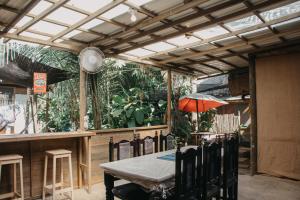 a dining room with a table and chairs and a patio at Casa Austera in El Paredón Buena Vista