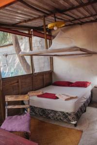 a bedroom with a bed in a room with a window at Casa Austera in El Paredón Buena Vista