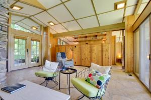 a living room with chairs and a table at Tranquil Mid-Century Modern Cottage with Forest View in Hardy