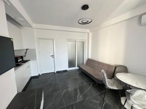 a living room with a couch and a table at MatyMar Black & White in Agigea