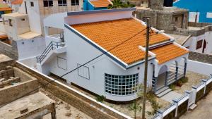 an overhead view of a white building with an orange roof at Djon’s Place in Mindelo