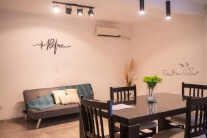 a dining room with a table and a couch at EmBruHadas Relax in San Salvador de Jujuy