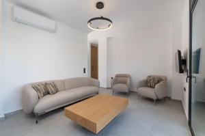 a living room with a couch and two chairs at Villa Nefeli in Meganisi