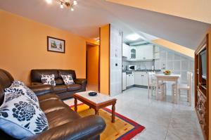 a living room with a couch and a table at Apartamentos Casa Paulino in Taramundi