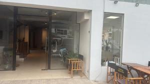 an open glass door of a building with tables and chairs at Hotel Ideal Termal in Termas de Río Hondo