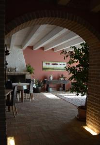 a dining room with a table and chairs in a room at Corte Spina in Lido di Spina