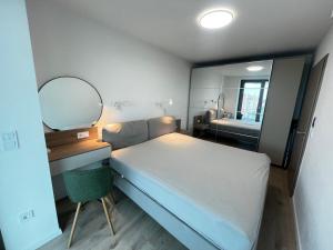 a small bedroom with a bed and a mirror at Summer Vibe Siófok - Wave in Siófok +33 photos