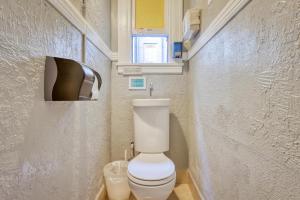 a small bathroom with a toilet and a window at HI San Francisco Downtown Hostel in San Francisco