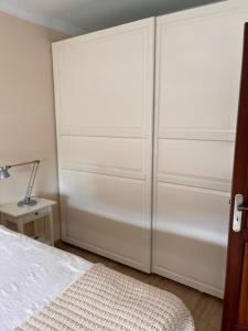 a bedroom with two large white closets and a bed at Arminda in Arguineguín