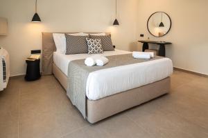 A bed or beds in a room at Depalyma Suites