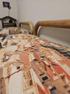 a bed with a comforter on top of it at La stella sulle terrazze in Zoagli