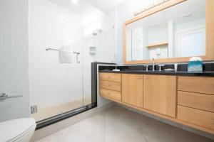 a bathroom with a sink and a shower and a mirror at South Bay Beach Club #25- 2 Bedroom 2 Bathroom Unit in George Town +6 photos