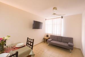 a living room with a couch and a table at Casa Dorada in Santa Cruz Huatulco
