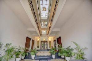 a hallway with potted plants in a building at Super Hotel O Plus Corporate One in Nagpur