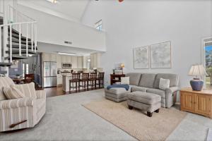 a living room with a couch and chairs and a kitchen at 34j GCR-Ortiz Oasis in Myrtle Beach