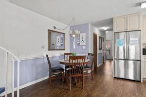a kitchen and dining room with a table and a refrigerator at 34j GCR-Ortiz Oasis in Myrtle Beach +43 photos