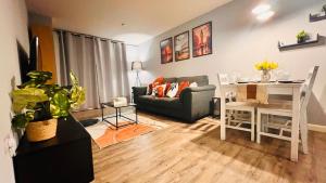 a living room with a couch and a table and a desk at Entire 2BR City Centre Skyline apartment with parking in Birmingham