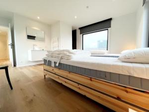 a bedroom with a large bed with a large window at Villa in Wenduine near the Beach in Wenduine