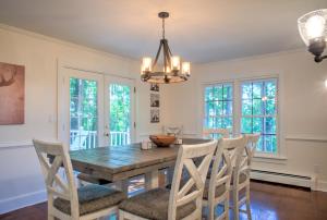 a dining room with a wooden table and chairs at Magic on the Hill by Carolina Mornings in Asheville