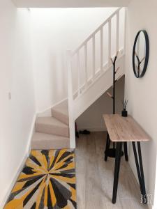 a white staircase with a wooden table and a rug at Cottage House - Preston Village - Preston Park in Brighton & Hove