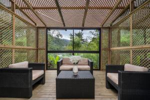 a room with chairs and a table with a vase of flowers at Bachelor Party Guard Jacuzzi Pool in Medellín