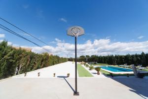 a street light next to a swimming pool at Luxury villa 20 minutes from Valencia in Lliria