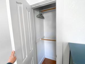 a person opening a door to a closet at Casa Carlos - In the heart of San Diego in San Diego