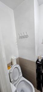 a bathroom with a white toilet in a room at Homey822 in Davao City +7 photos