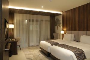 Ένα ή περισσότερα κρεβάτια σε δωμάτιο στο Forest Hills Hotel