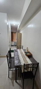 a dining room table and chairs in a room at Homey822 in Davao City