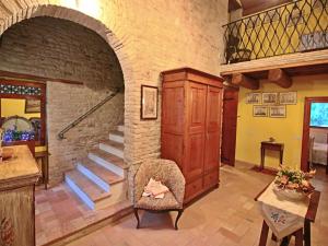 a living room with a staircase and a brick wall at Belvilla by OYO Casa Lella in Serrungarina