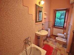 a bathroom with a sink and a toilet and a tub at Belvilla by OYO Casa Lella in Serrungarina +32 photos